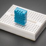 A DHT11 inserted into a small breadboard.